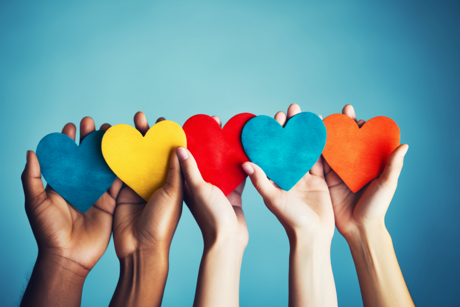 hands holding colorful hearts